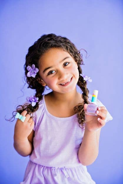 girl in purple holding lilac nail polish