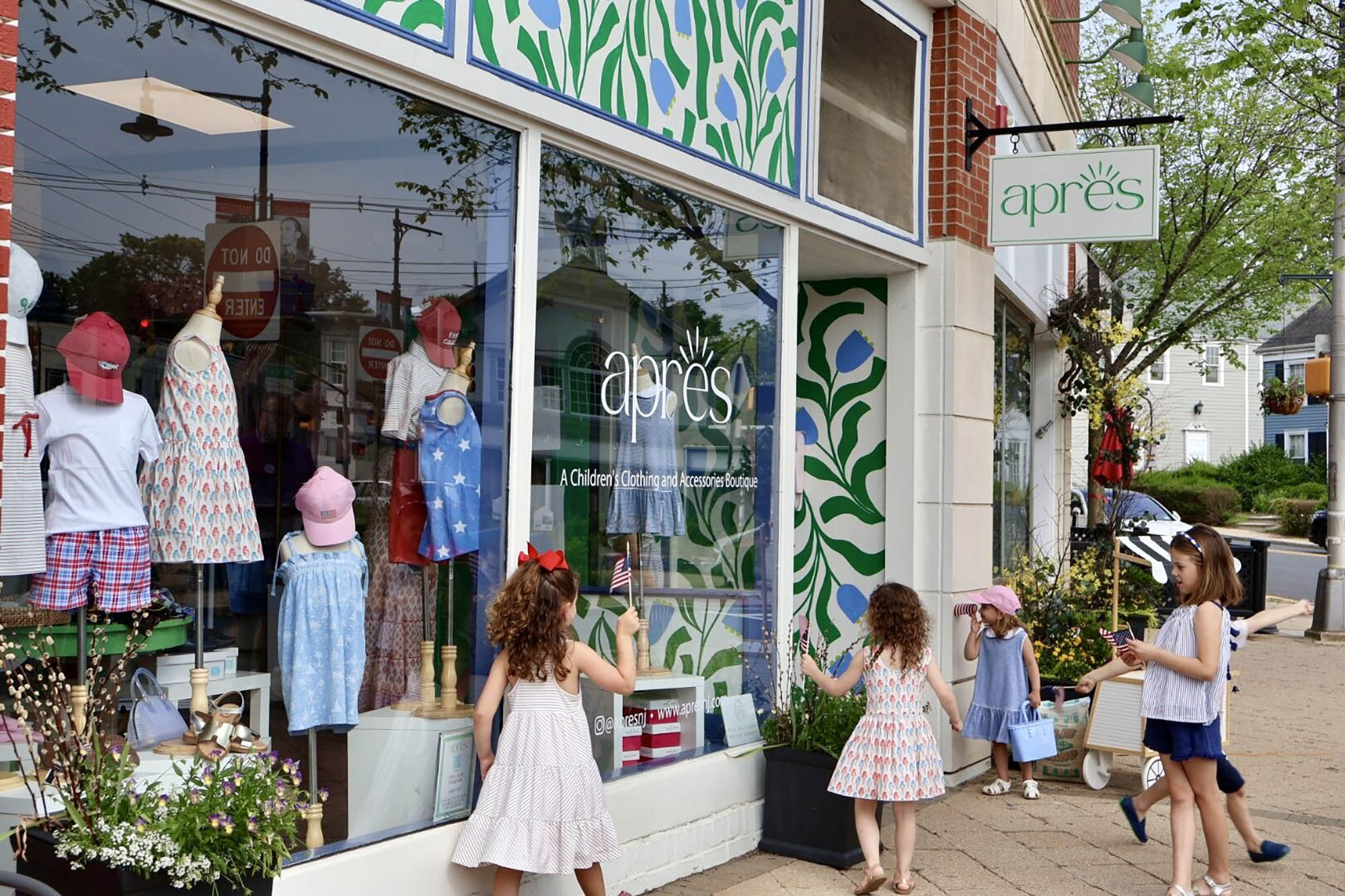 children standing in front of the Apres Boutique Storefront