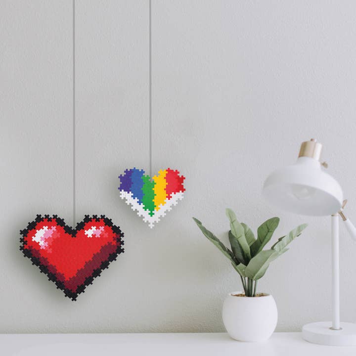 two heart puzzles handing on the wall