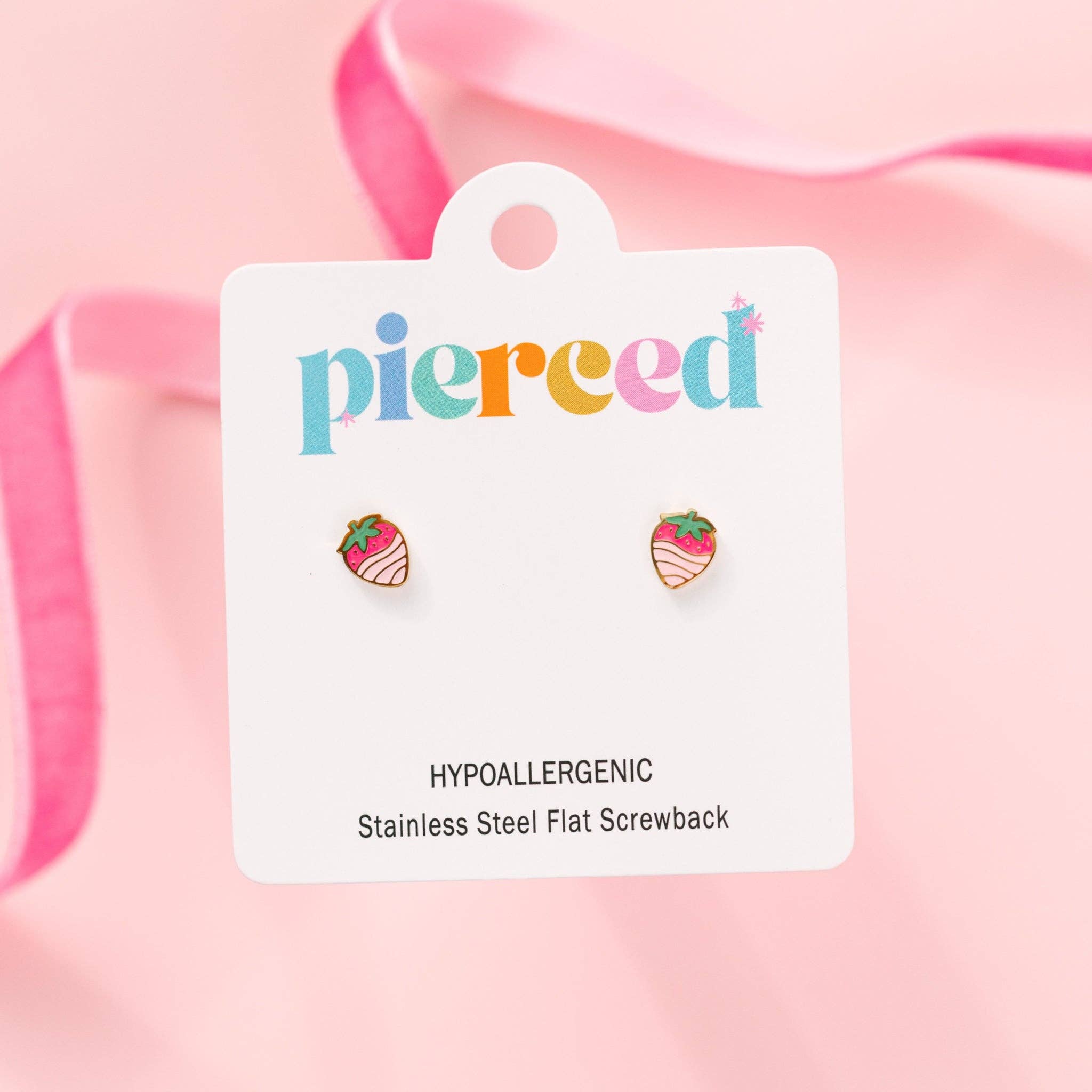 Strawberry-shaped earrings on a 'pierceed' branded card with pink background