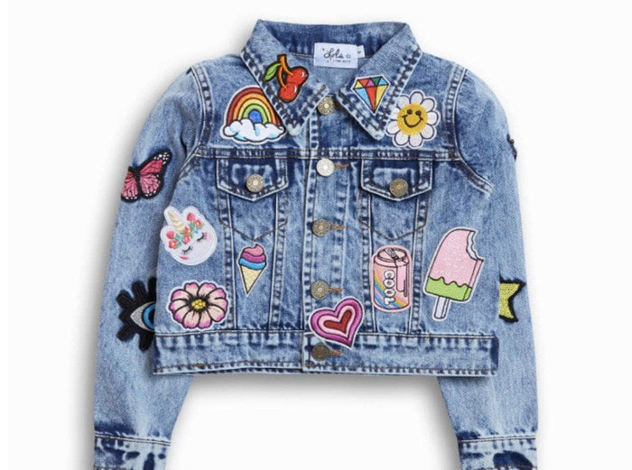 Denim jacket with colorful patches on a white background
