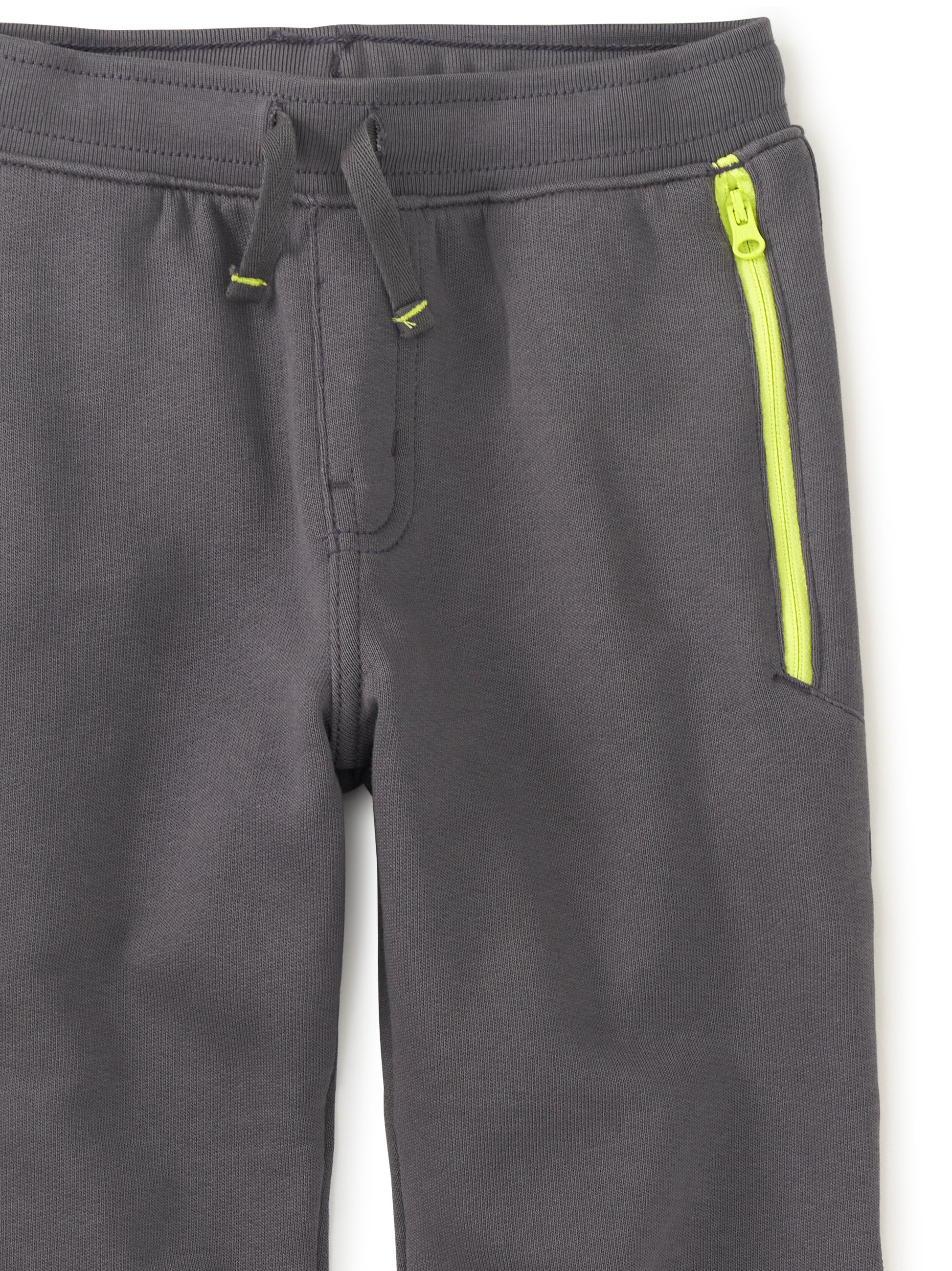 neon yellow pocket zipper on gray joggers