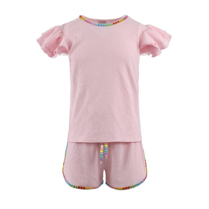 Pink children's outfit with gem rainbow trim on a white background