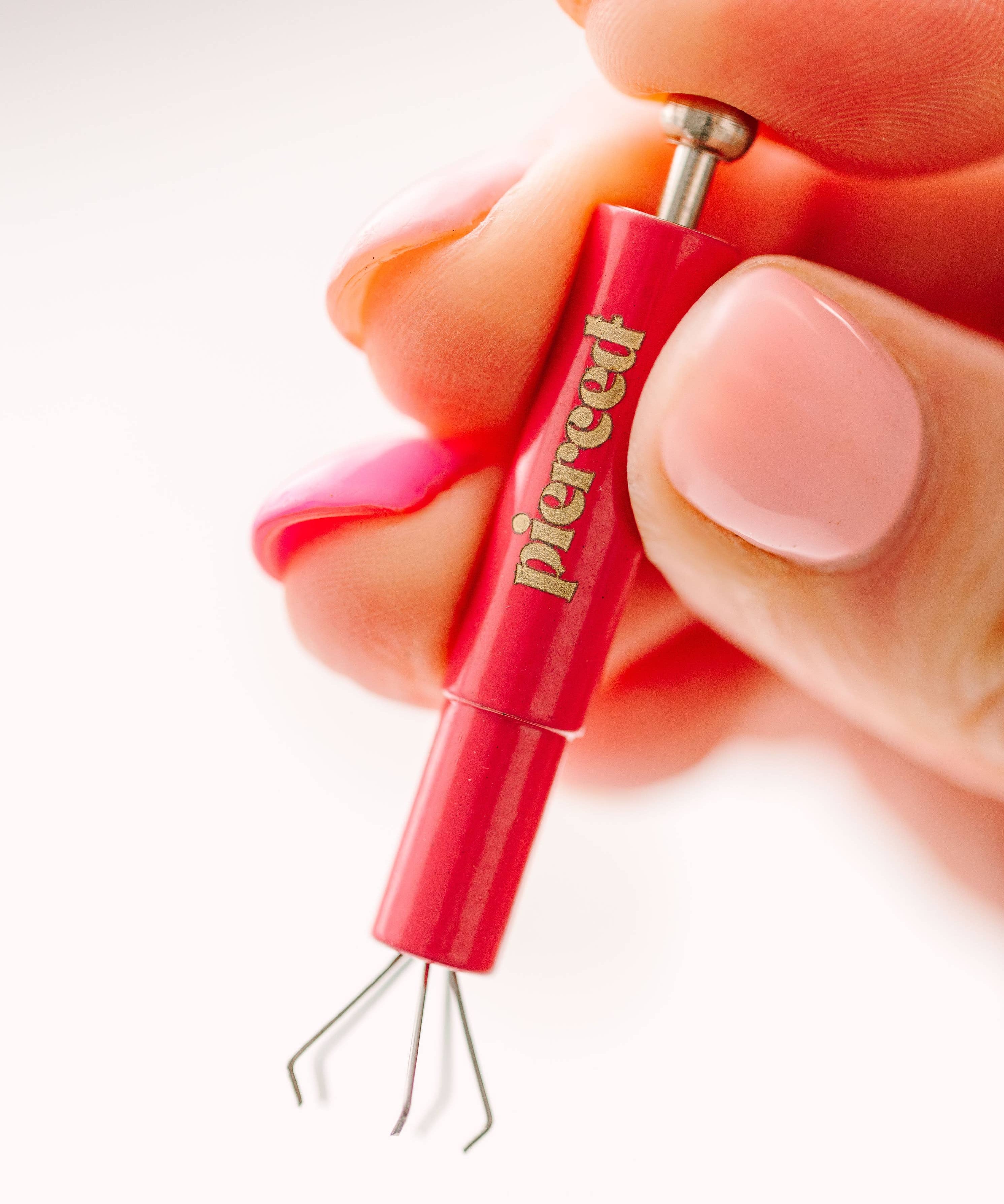 hand holding an earring back tool 
