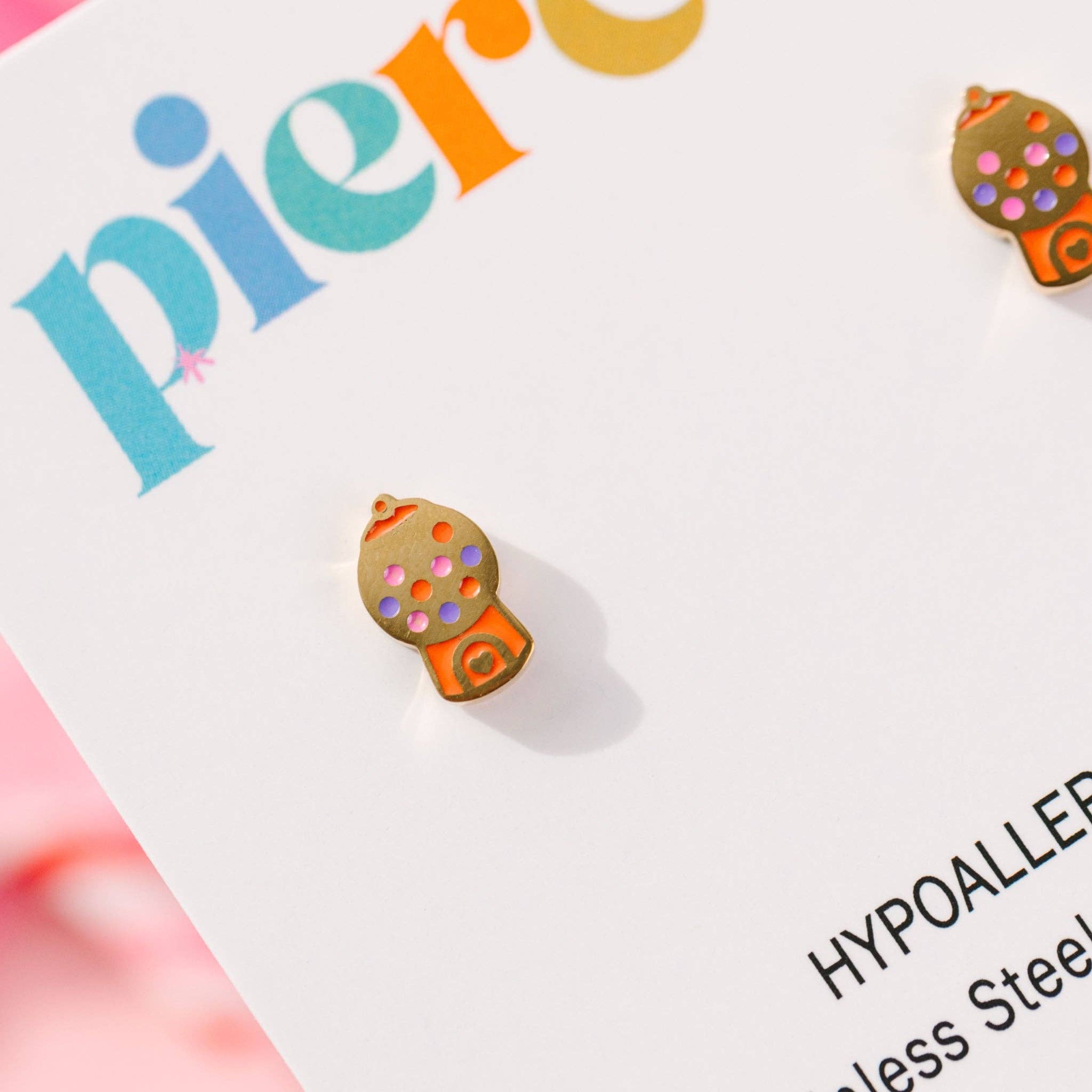 Colorful earring on a 'pierced' card with visible brand name. gold gumball earrings 