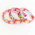 Three colorful floral-patterned headbands on a white background