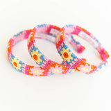 Three colorful floral-patterned headbands on a white background
