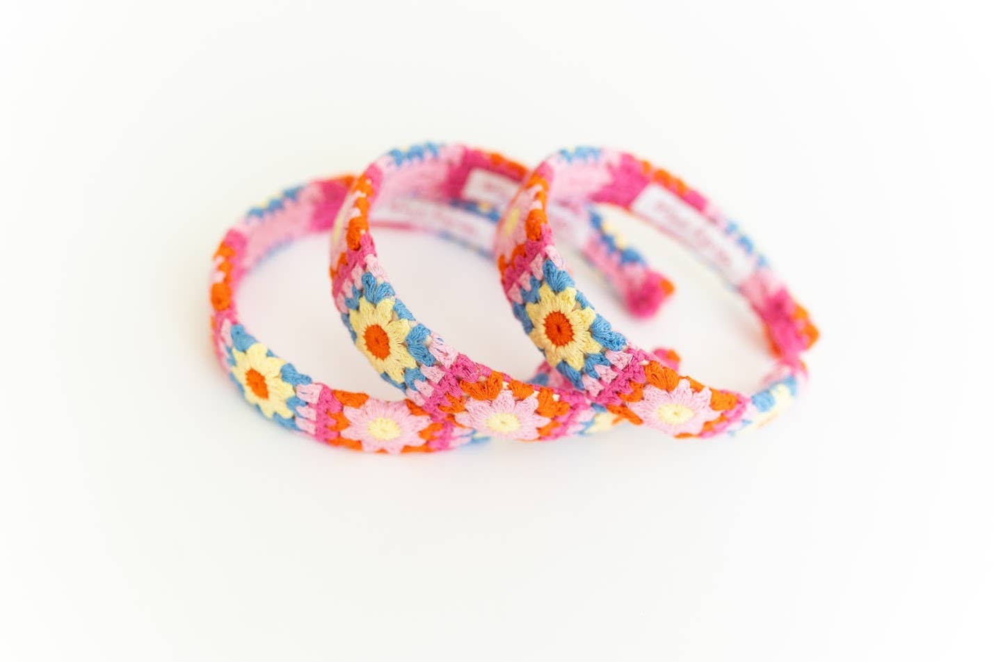 Three colorful floral-patterned headbands on a white background