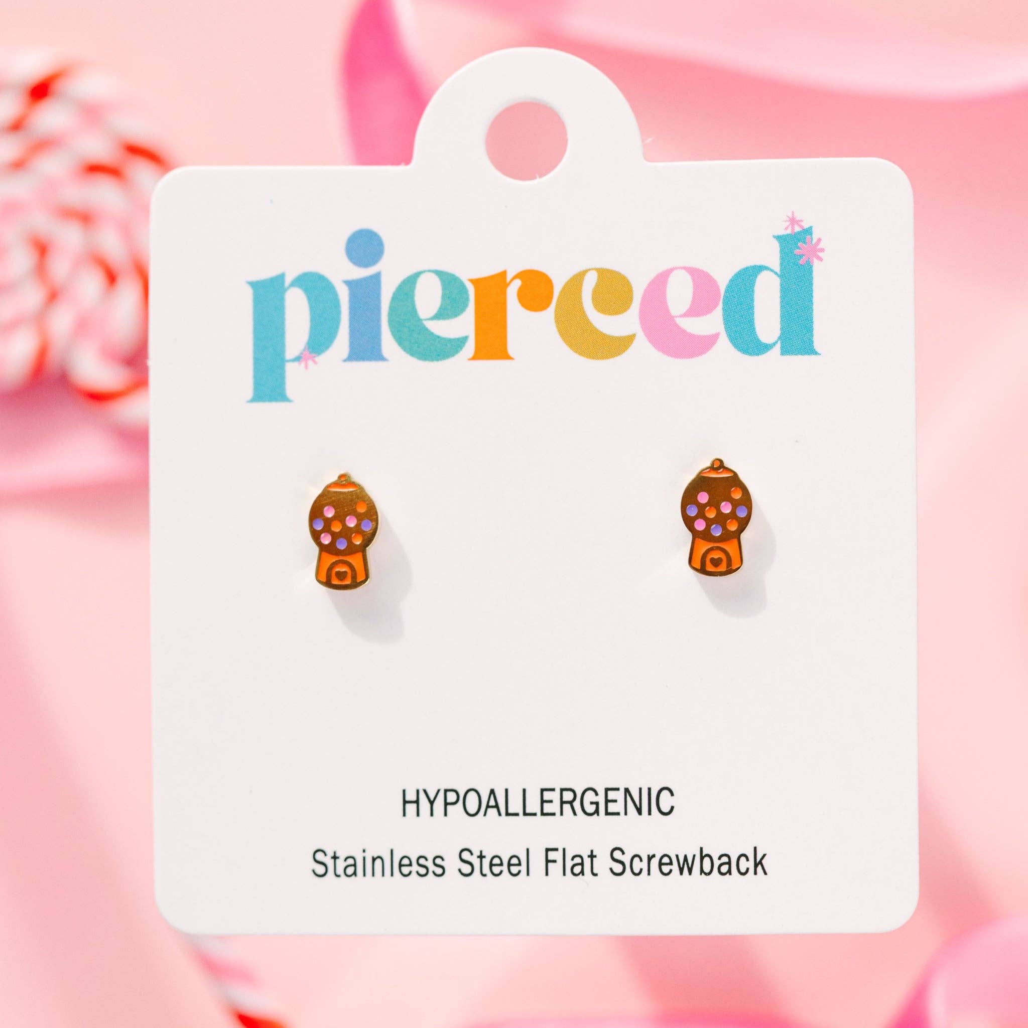 Earring card with 'pierceed' brand and colorful gumball earrings on a pink background