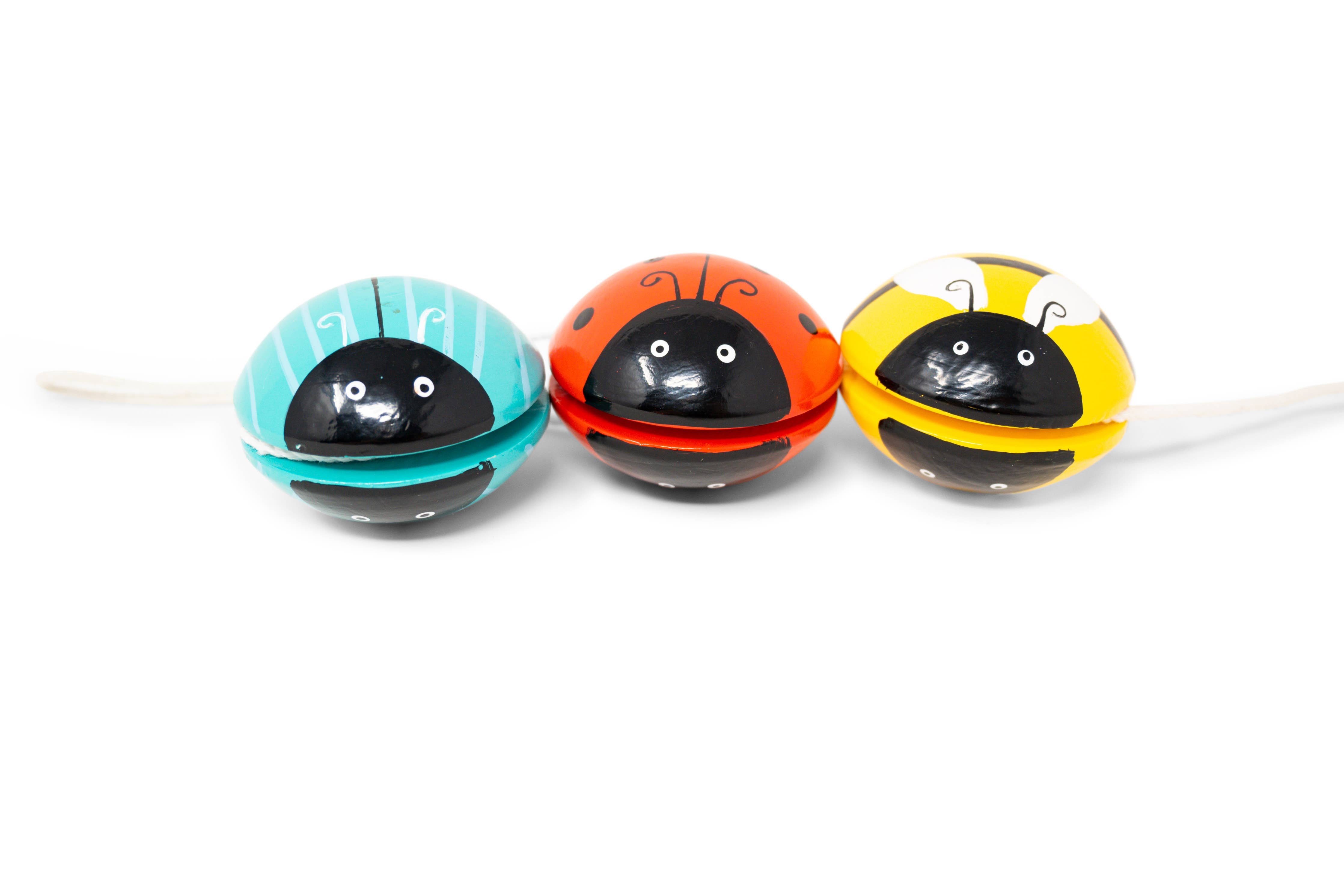 Three colorful ladybug-shaped yo-yos facing front on a white background