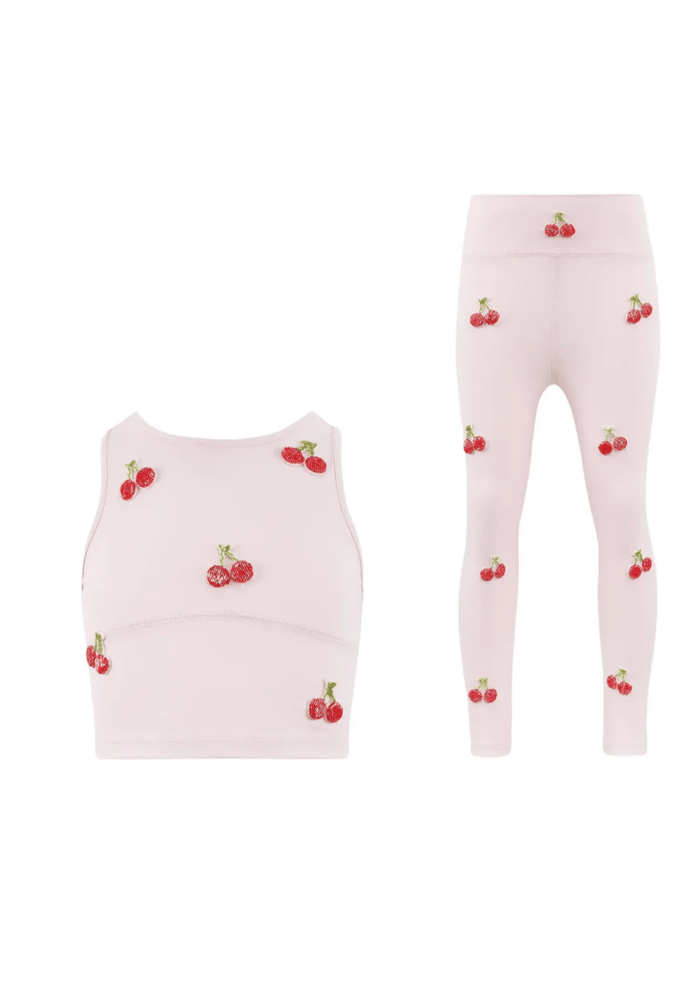 Pink children's tank top and leggings set with cherry pattern on a white background