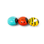 Three colorful bug-shaped yo-yos on a white background
