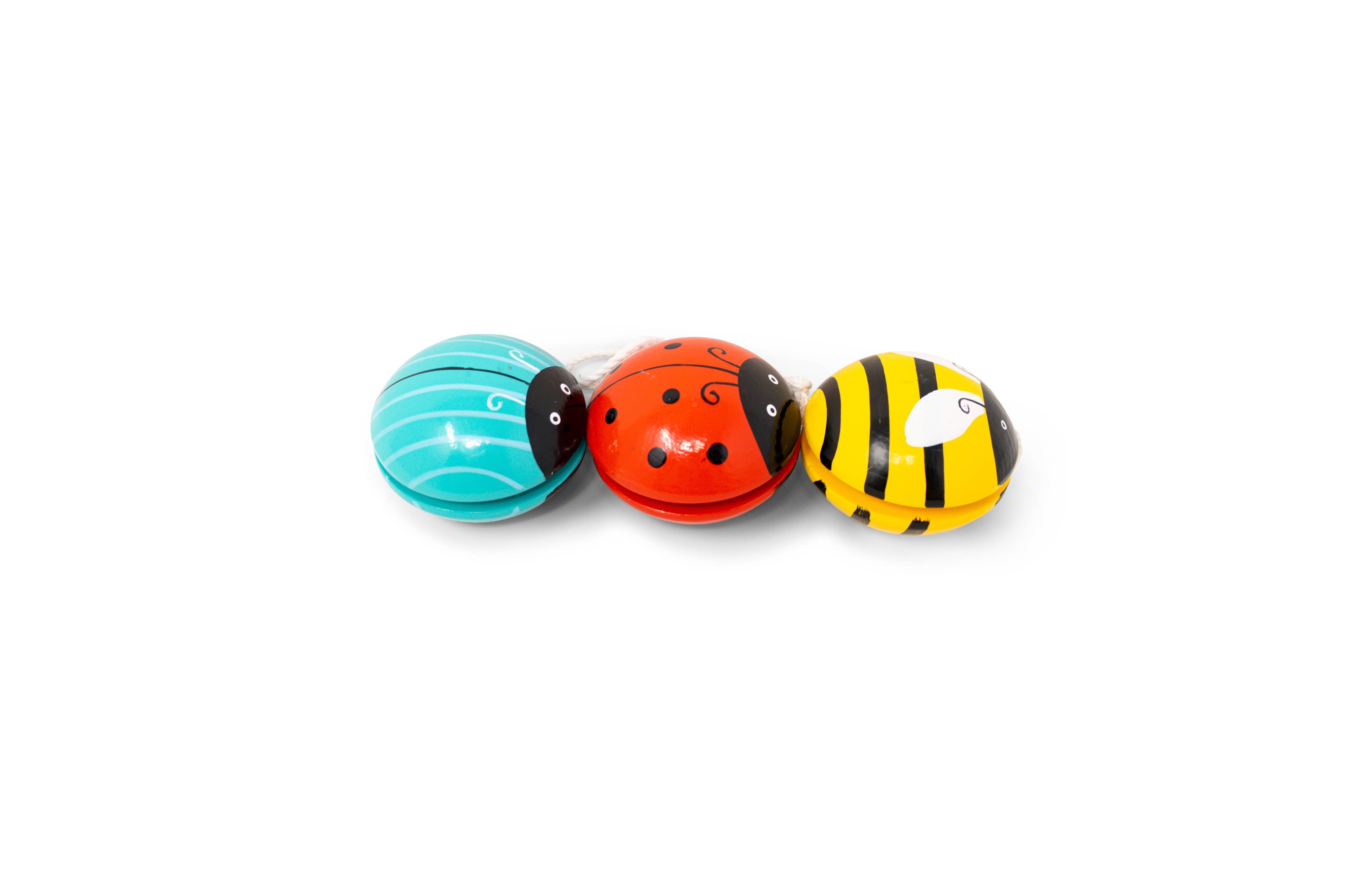 Three colorful bug-shaped yo-yos on a white background