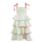 White dress with colorful trim and pink straps bows on a white background