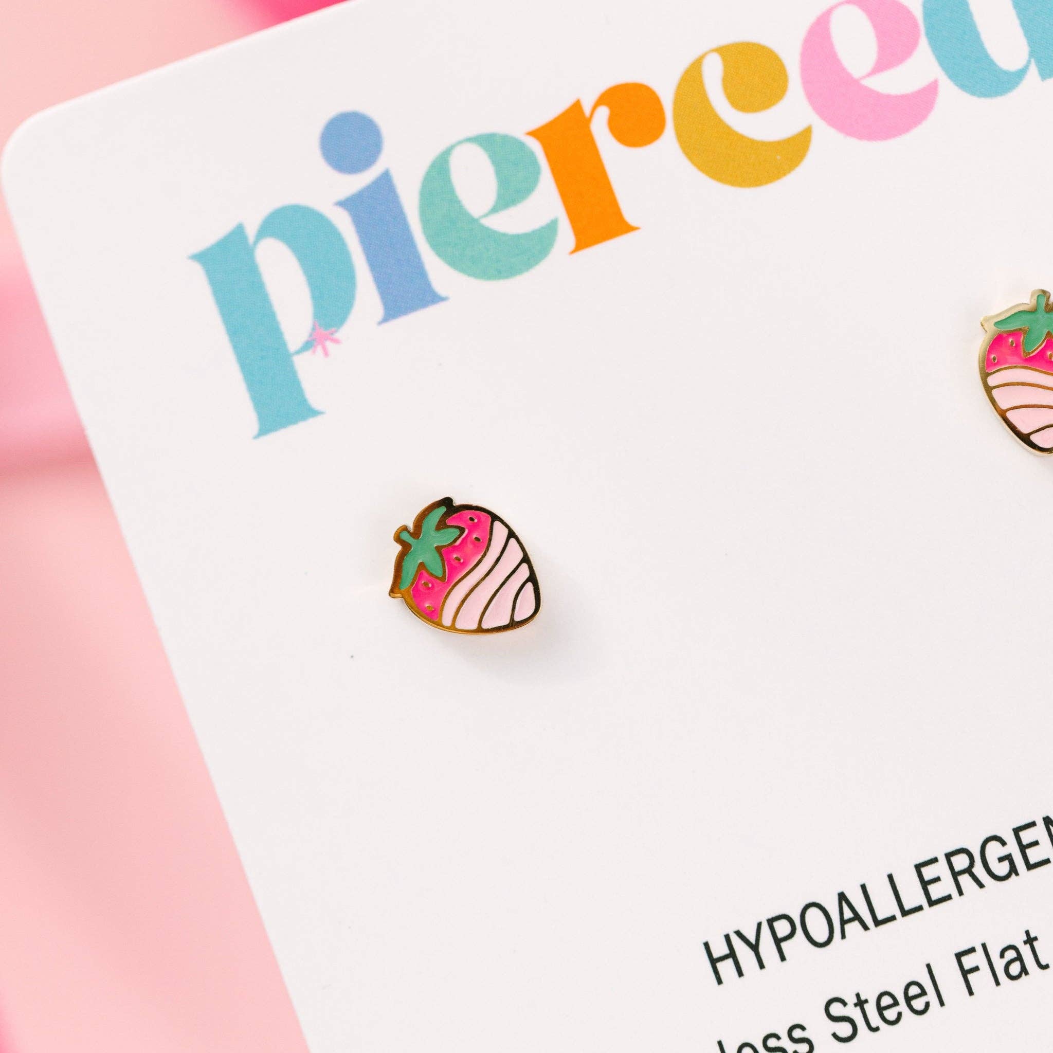 Strawberry-shaped earrings on a 'pierce' card with colorful text.