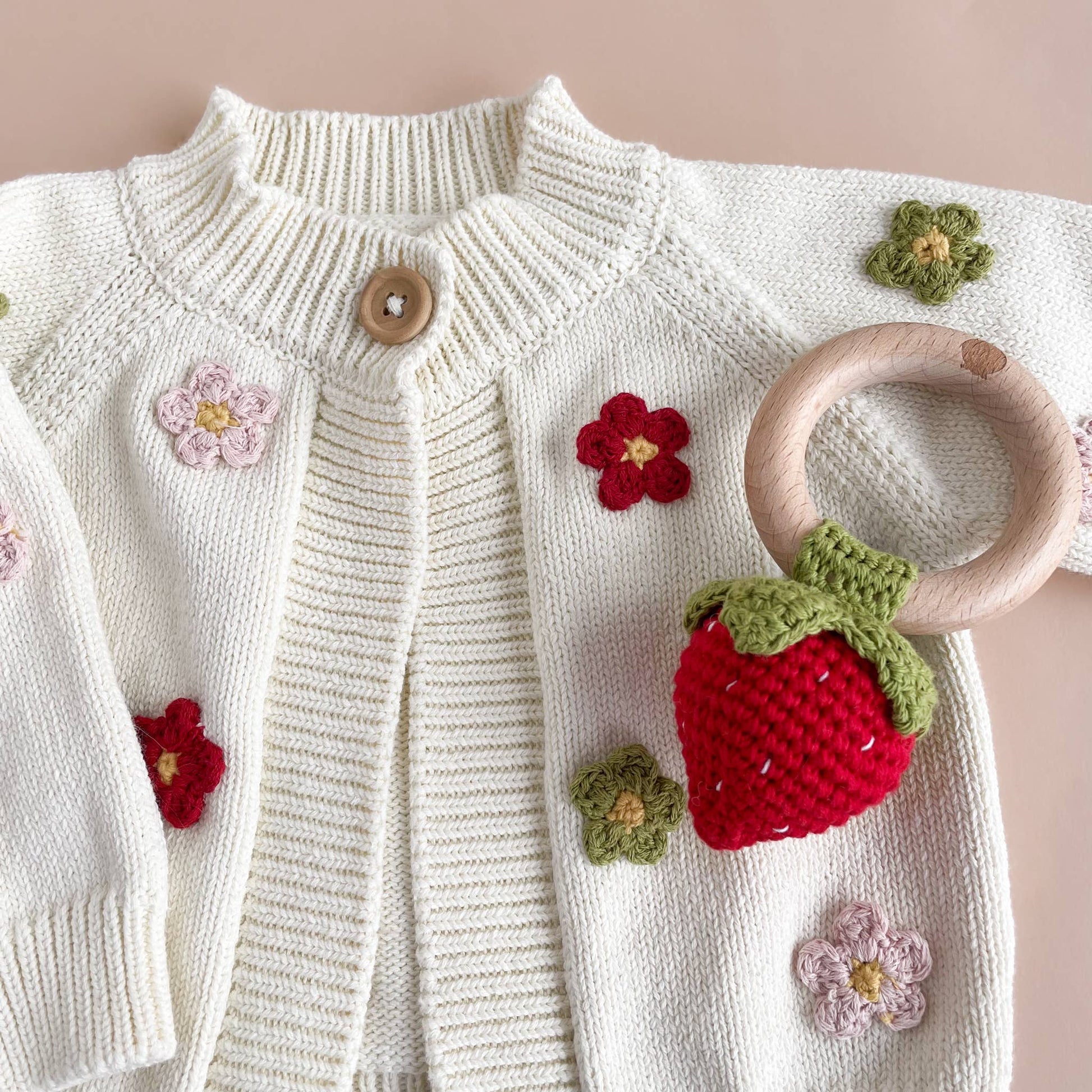 crochet strawberry rattle teether with sweater 