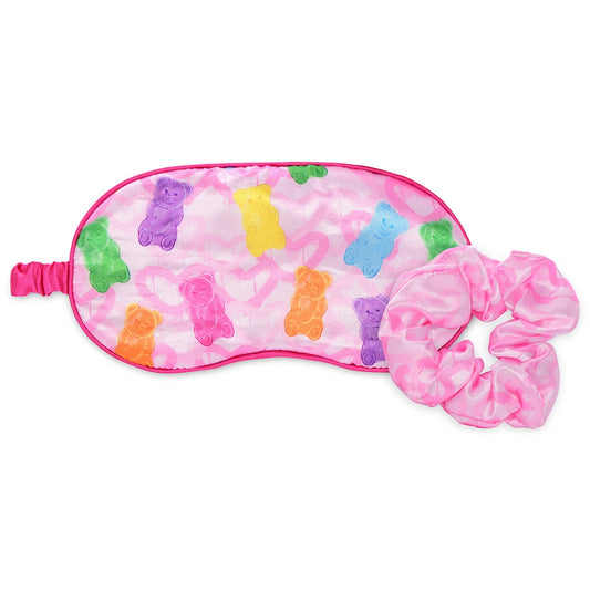 Pink eye mask with colorful gummy bears and a pink hair scrunchie