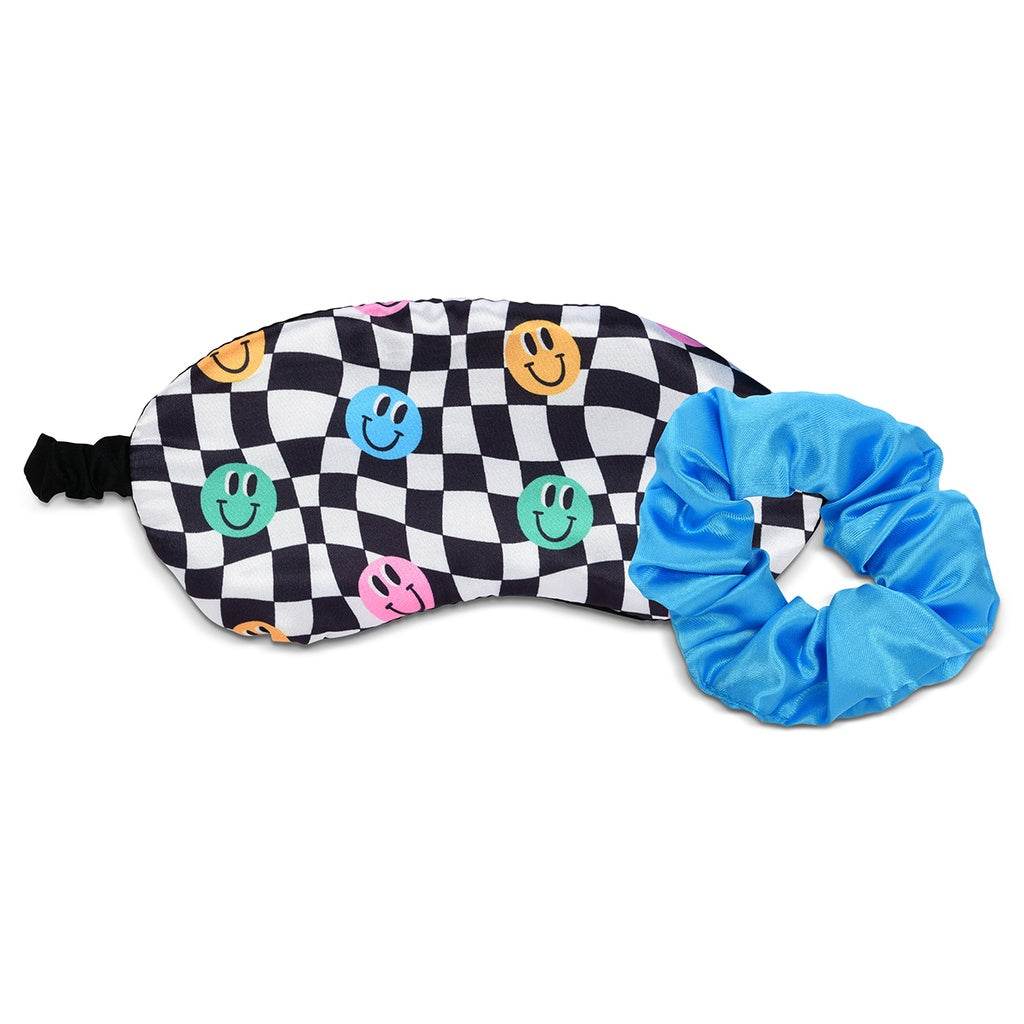 Black and white checkered eye mask with colorful smiley faces and a blue scrunchie