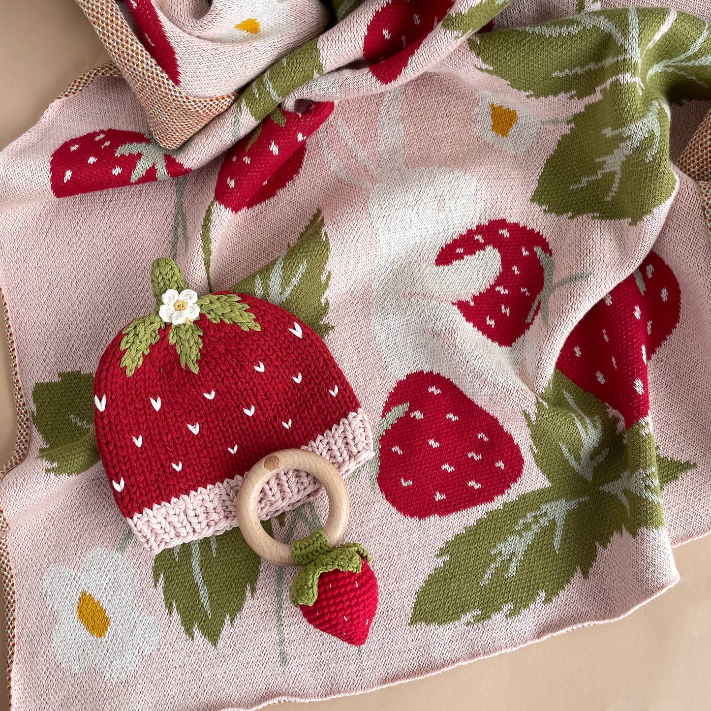 hat and rattle with strawberry blanket 