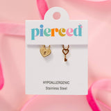Heart lock and key charm for hoop earrings on a 'pierceed' branded card with pink background
