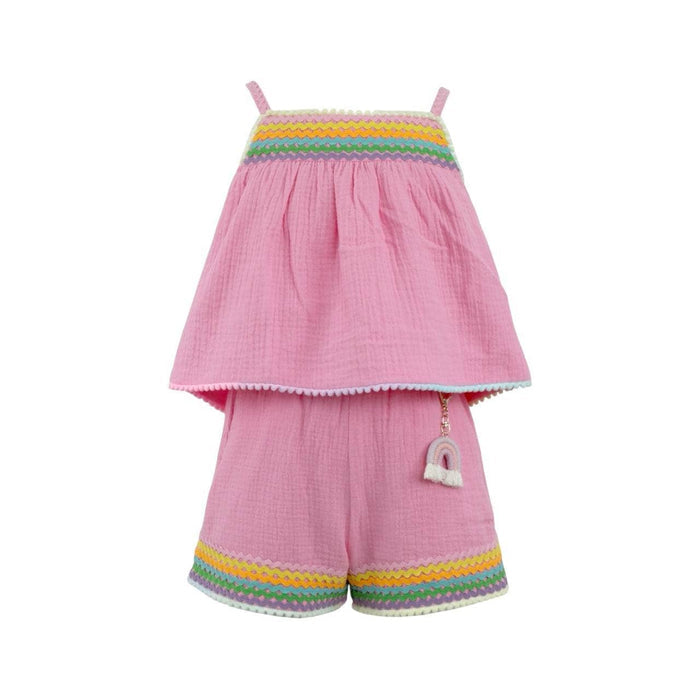 Pink children's outfit with rainbow trim on a white background