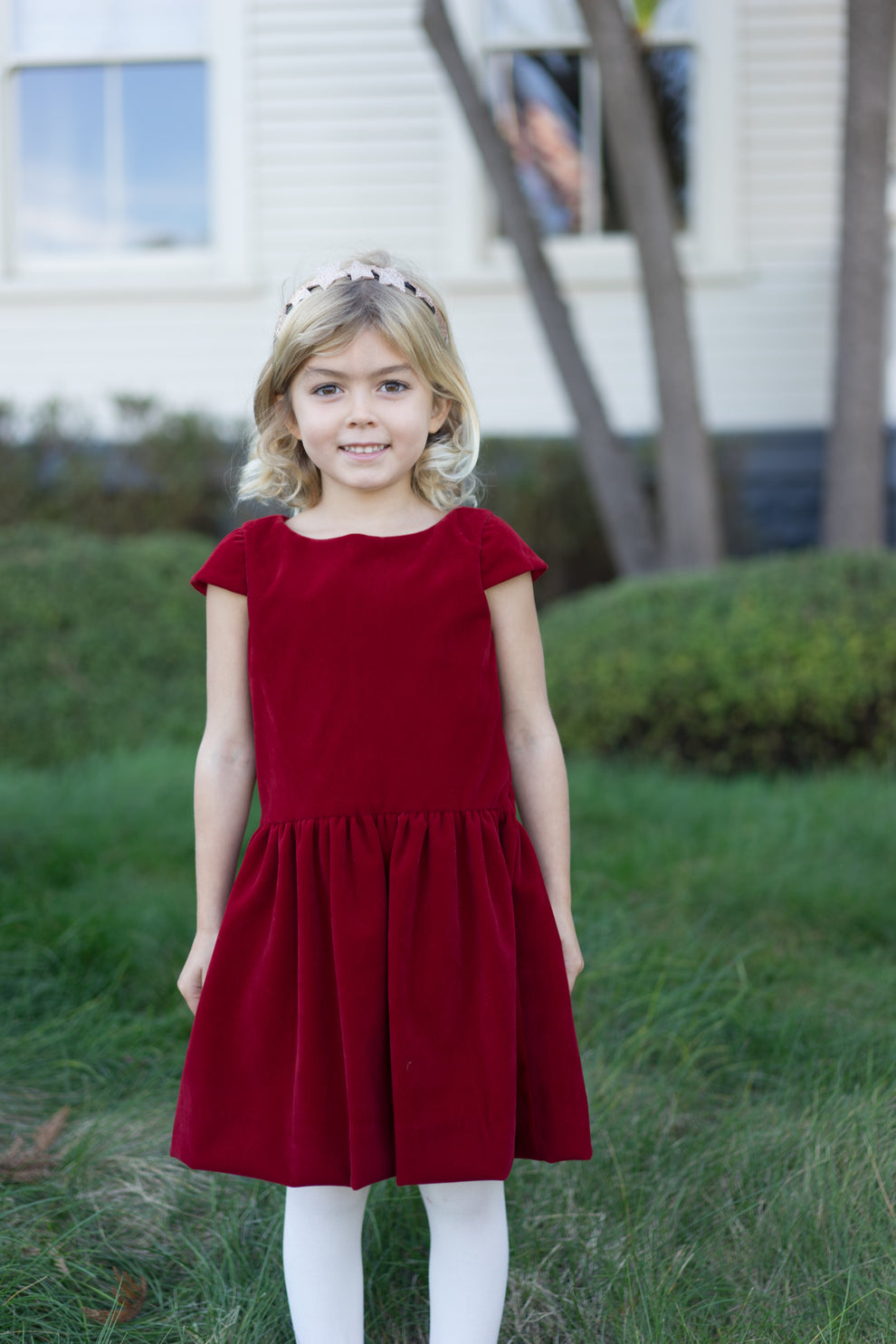 girl in red velvet drop waist dress