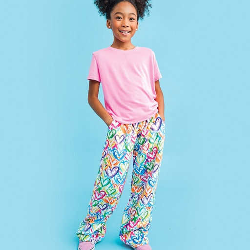 Girl wearing multi colored heart pants