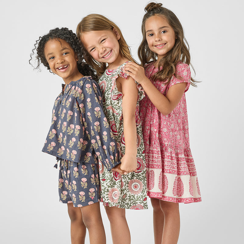 3 girls standing in dresses and ava floral top 