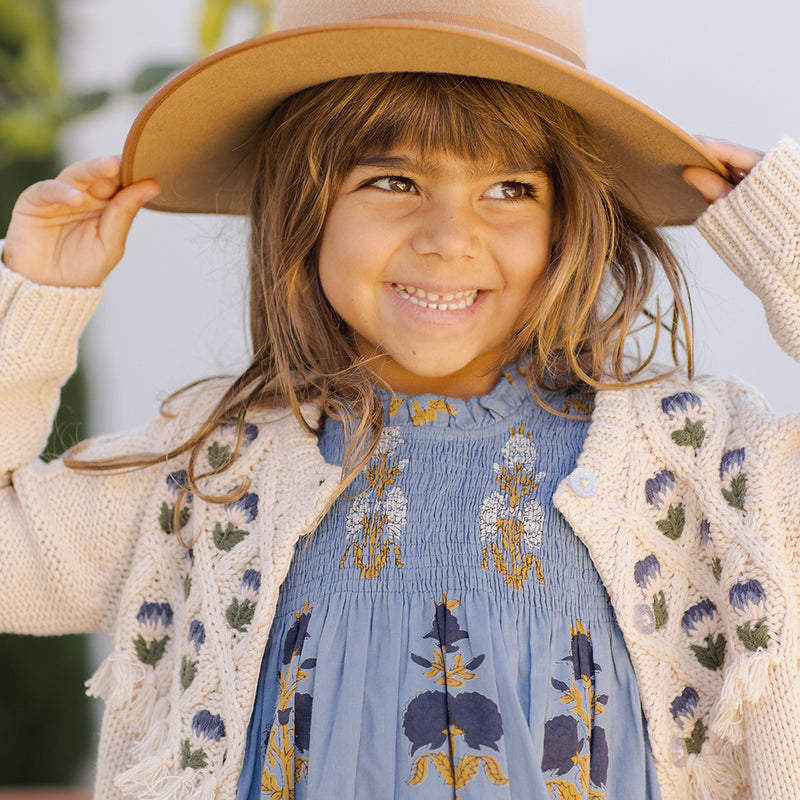 girl wearing Stevie Dress in blue flowerette 