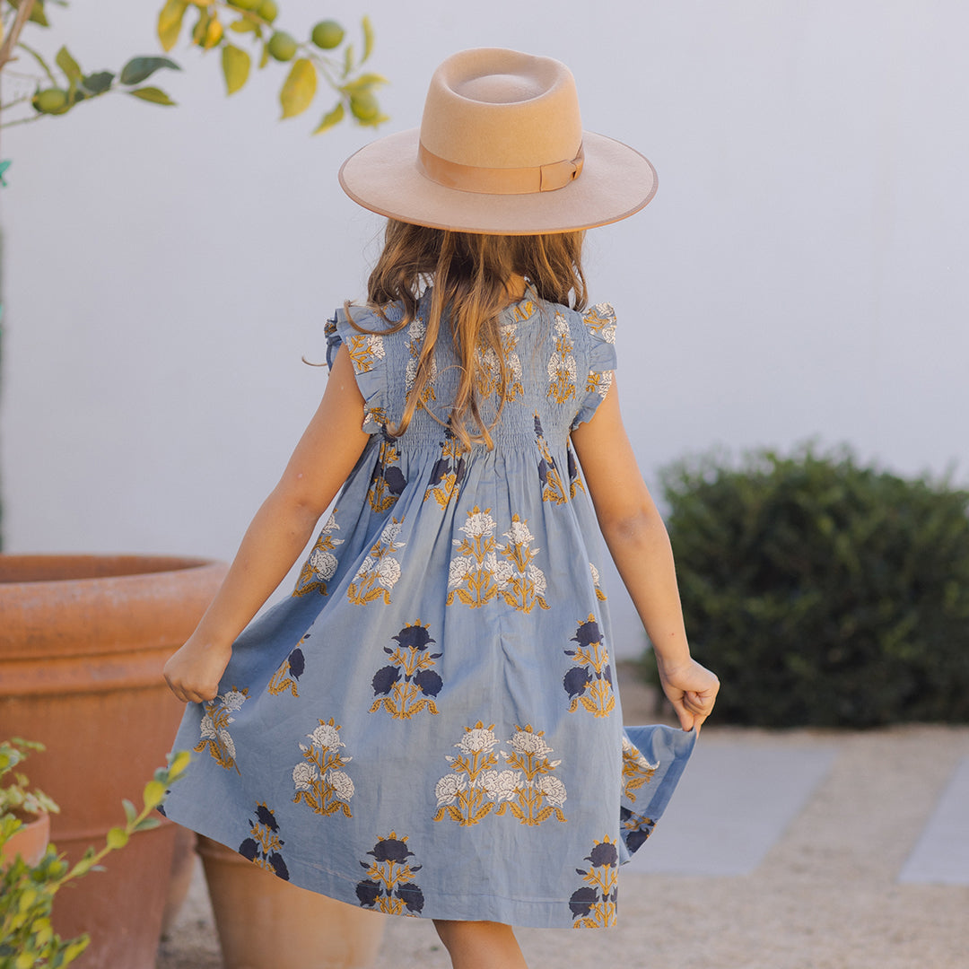 back of girl wearing Stevie Dress in blue flowerette 