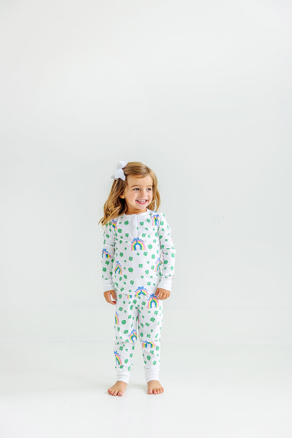 Little girl wearing Sara Janes Sweet Dream Set with rainbows and shamrocks 