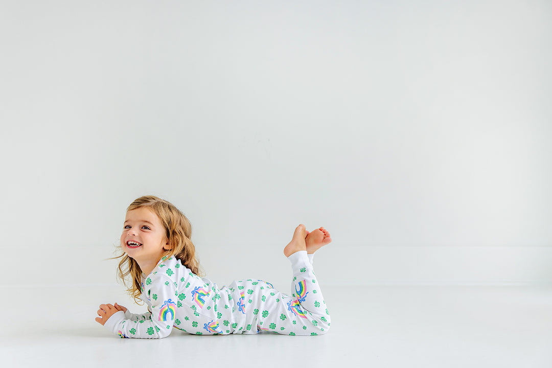 Little girl wearing Sara Janes Sweet Dream Set with rainbows and shamrocks