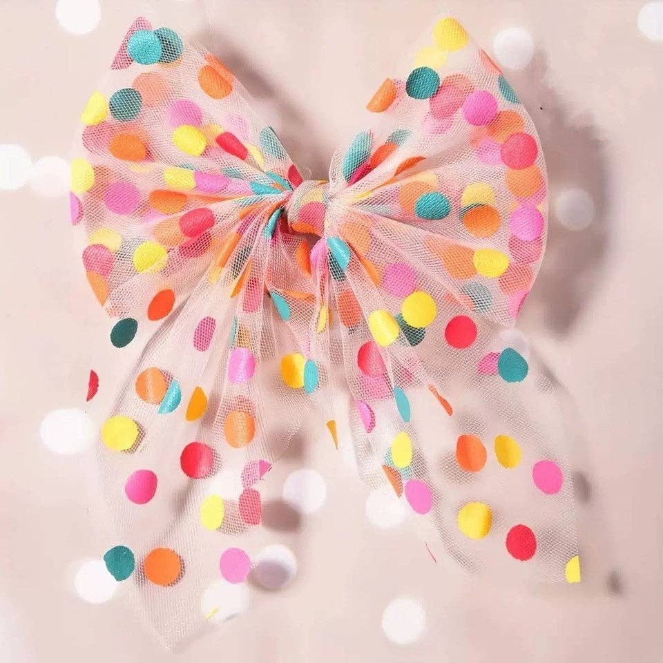 Colorful polka dot bow on a beige background