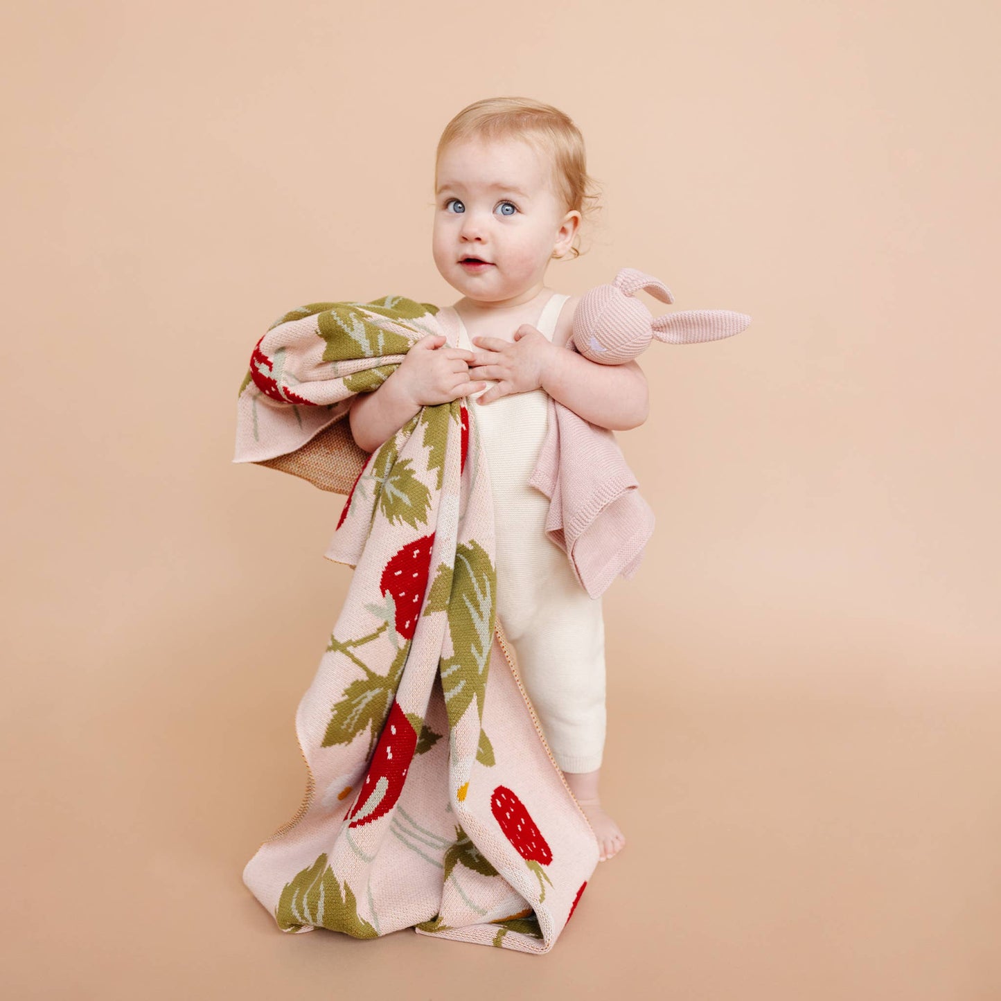 baby with strawberry blanket 