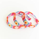 Set of colorful floral-patterned headbands on a white background