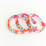 Set of colorful floral-patterned headbands on a white background