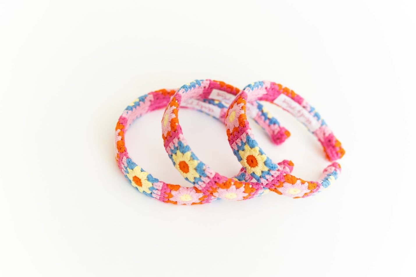 Set of colorful floral-patterned headbands on a white background