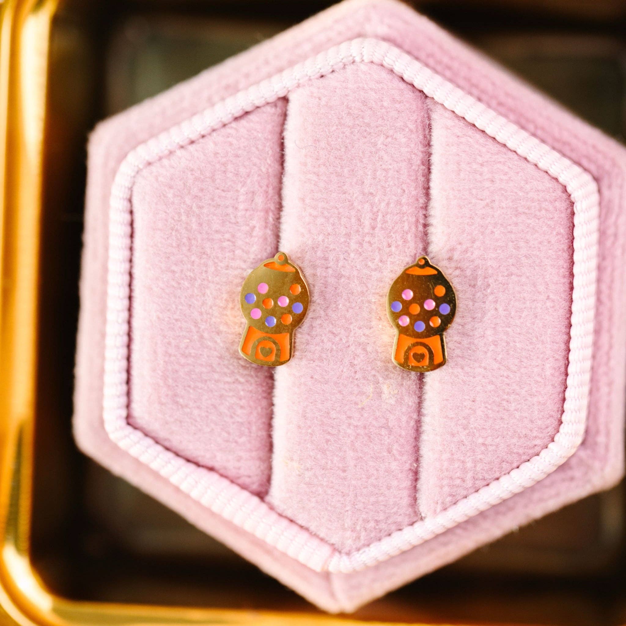 gold gumball earrings in pink box 
