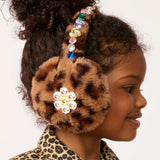Child wearing a leopard print headband with decorative elements on a plain background