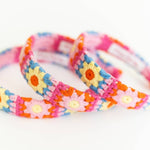 3 Colorful flower-patterned headbands on a white background