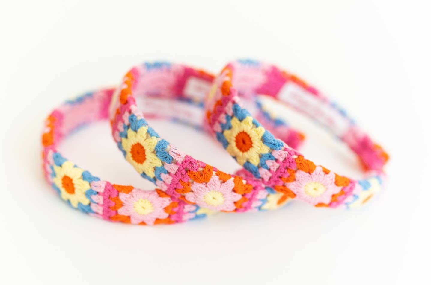 3 Colorful flower-patterned headbands on a white background