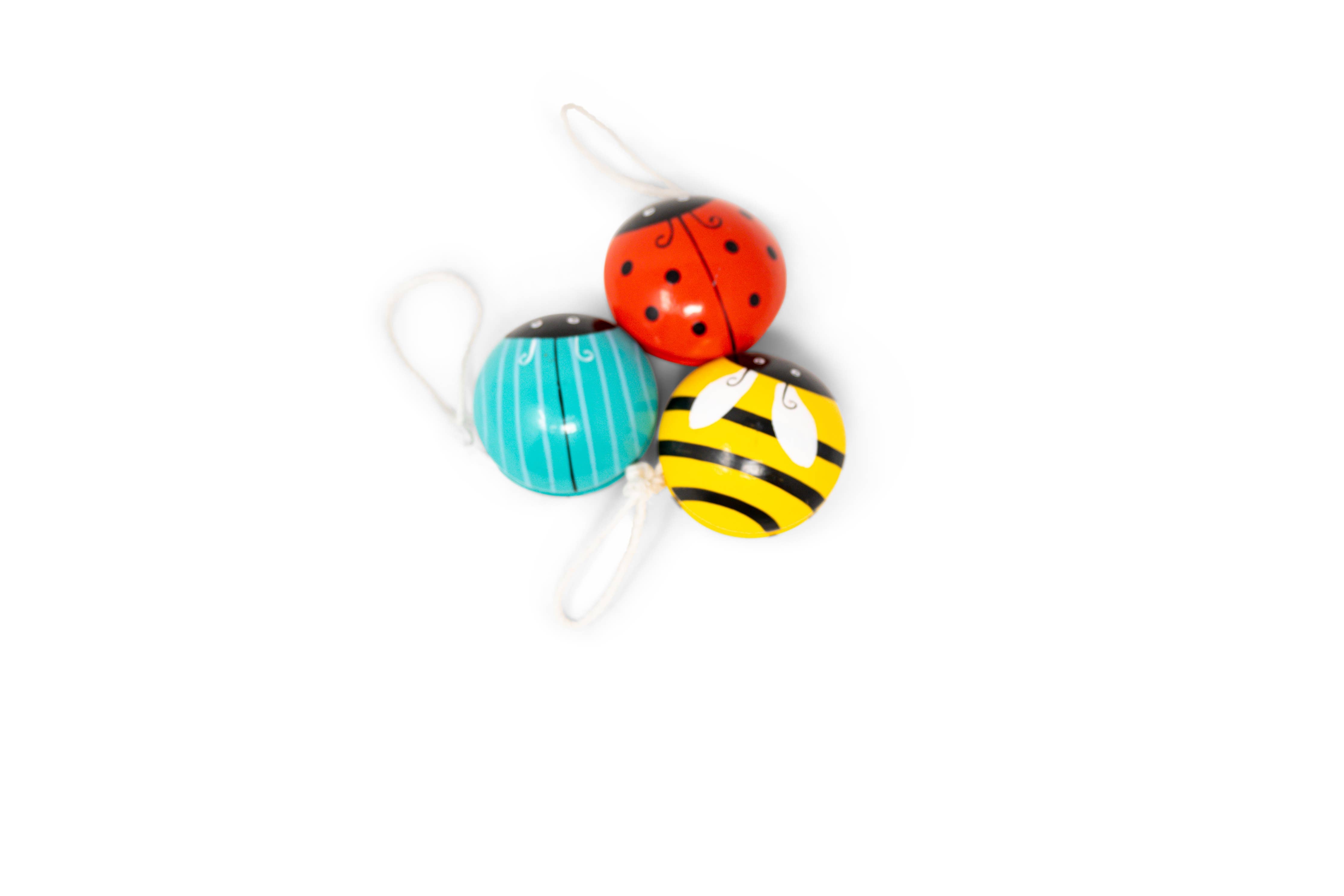 Three colorful yo-yos shaped like ladybug, bee, and beatle on a white background