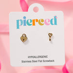 gold heart-shaped lock and key earrings  on a 'pierced' branded card with pink background