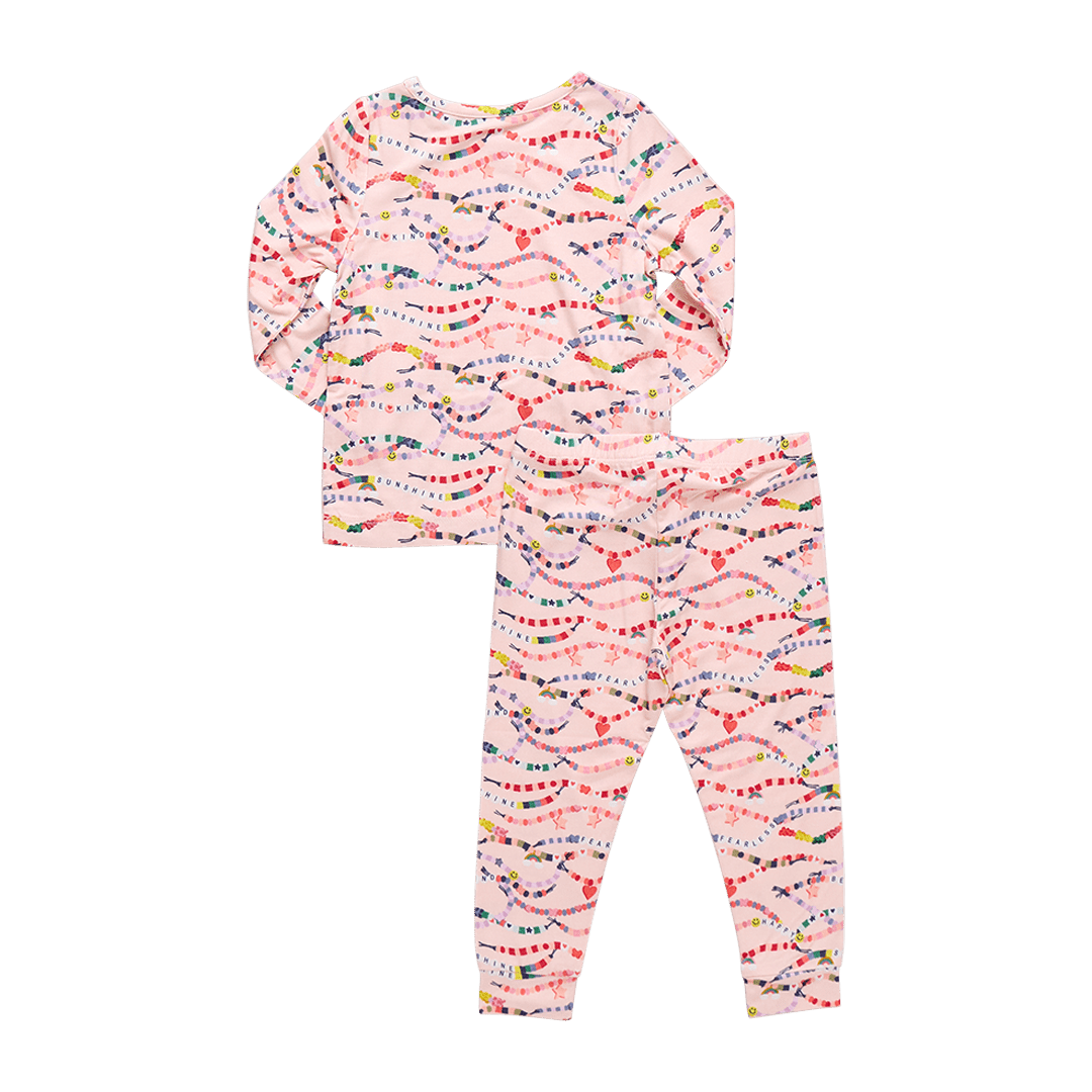 light pink long sleeved pajama set with colorful friendship bracelets