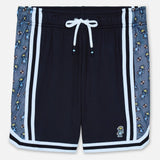 Black shorts with patterned side panels on a white background