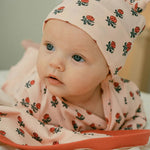 Baby wearing flower hat and onesie